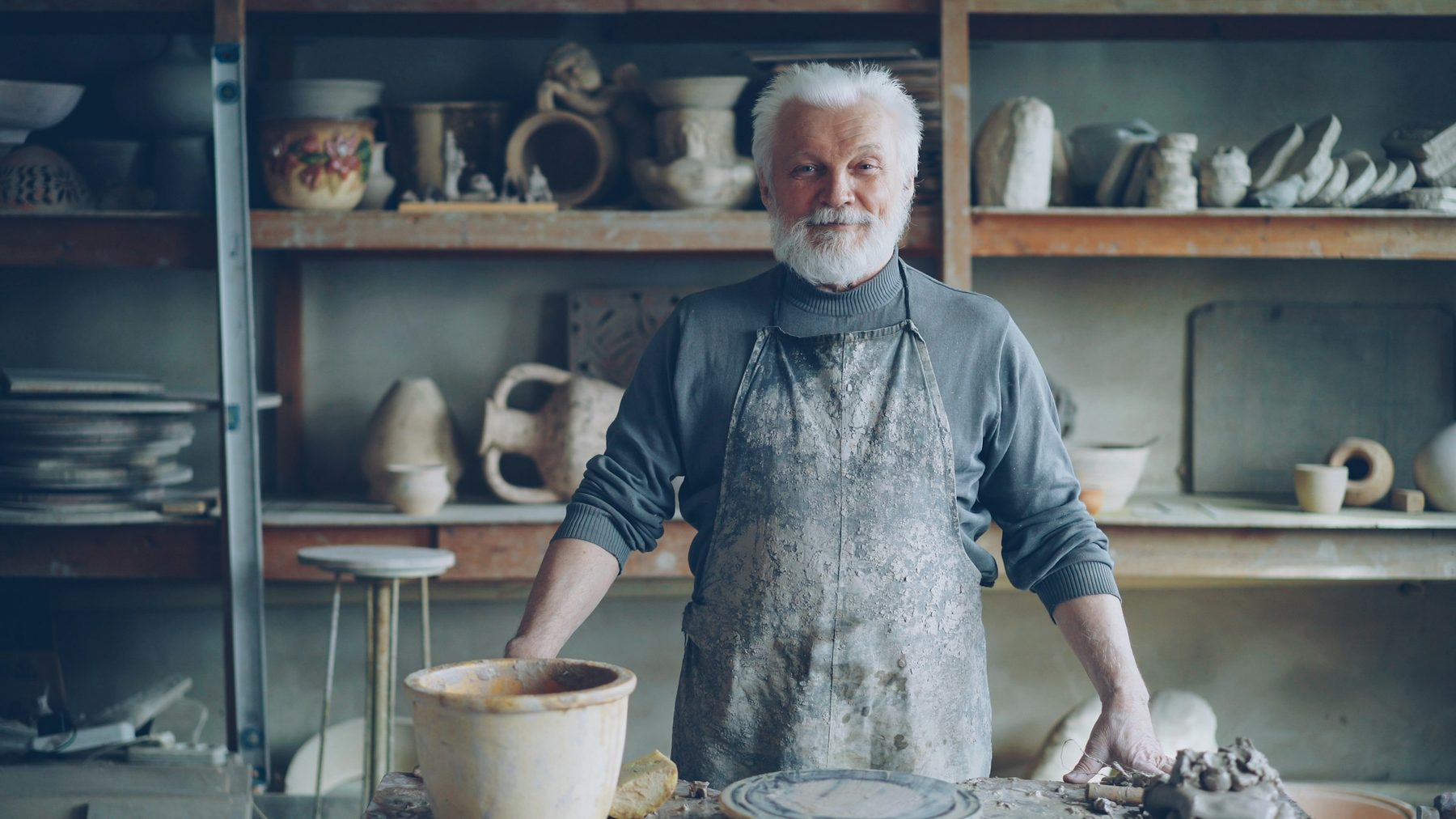 A potter standing in his workshop