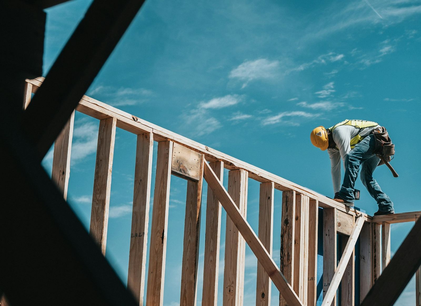 A framer working on the wood frame of a new building