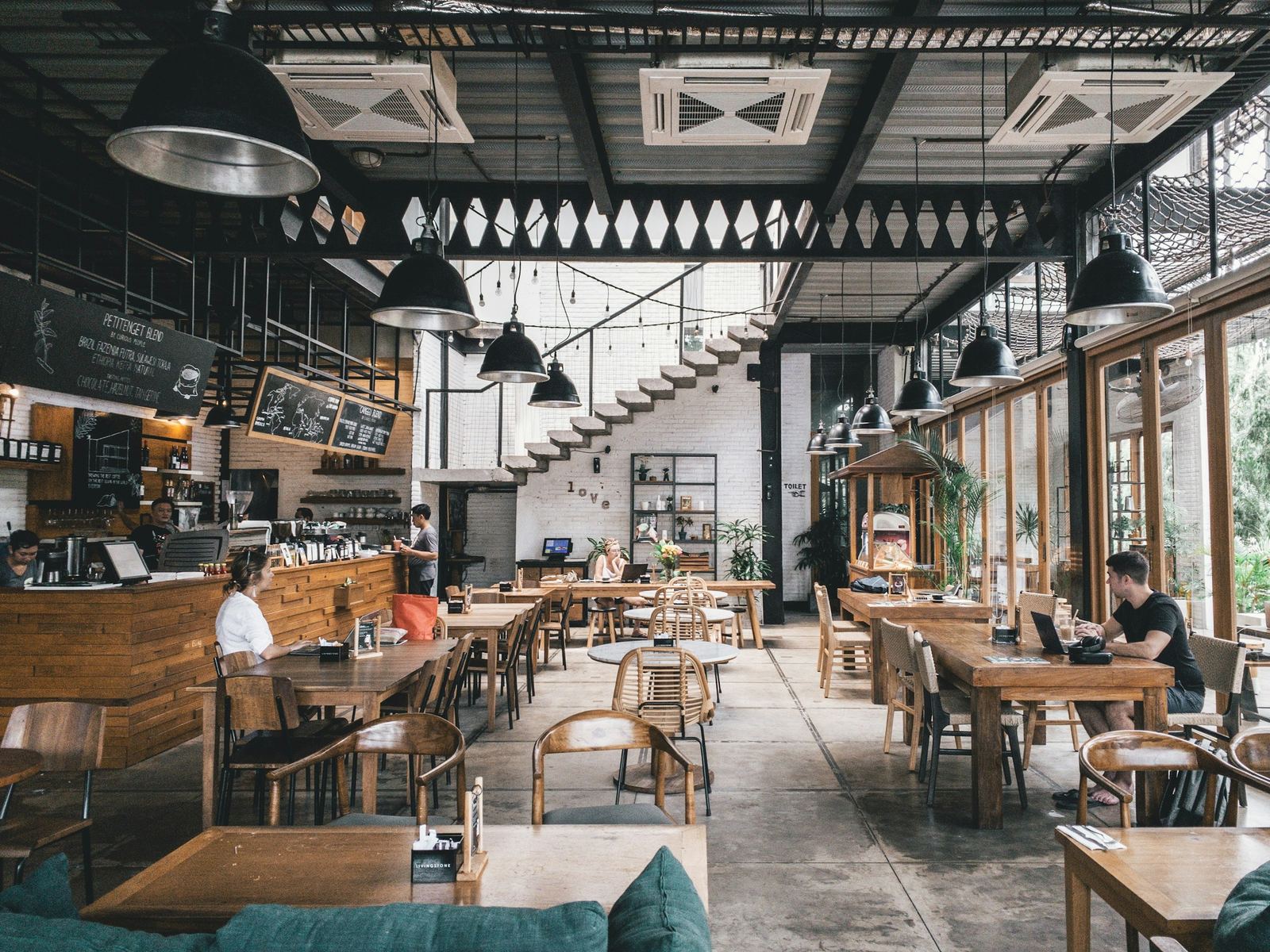 A busy cafe dining room with wooden tables