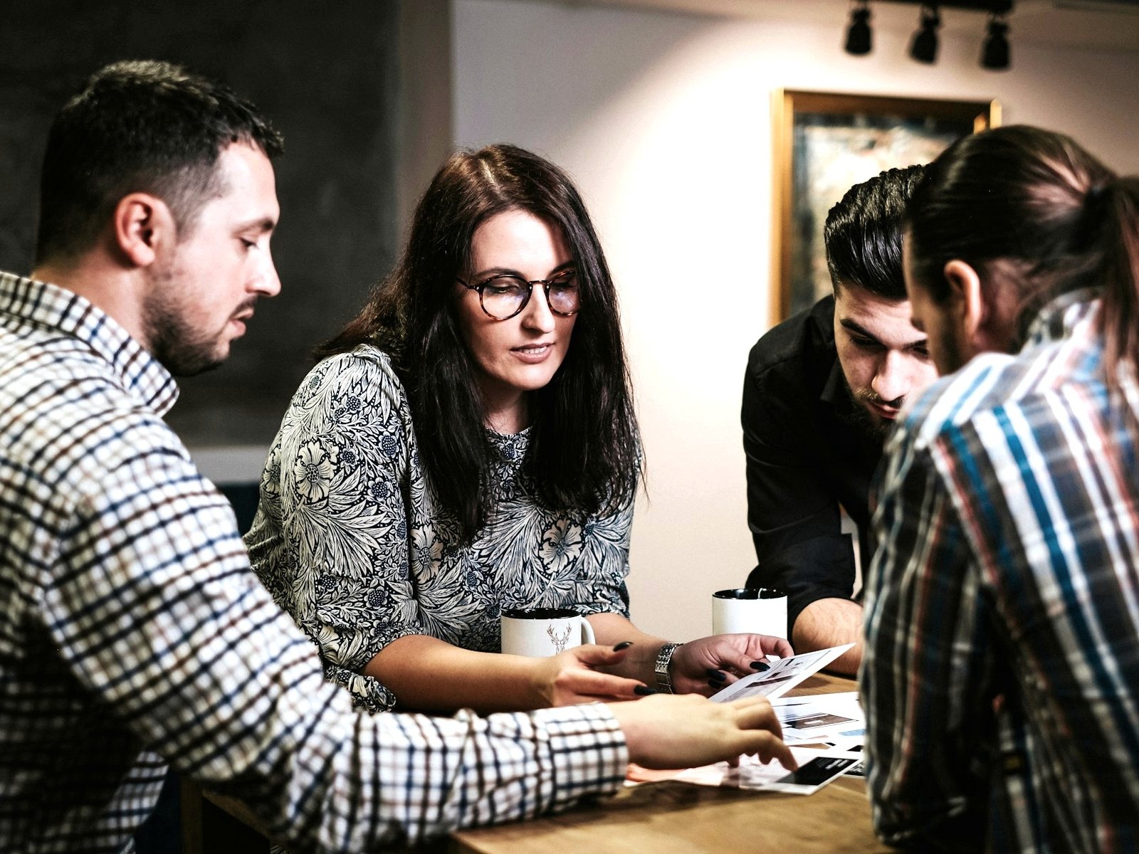 Two colleagues reviewing documents together at a desk