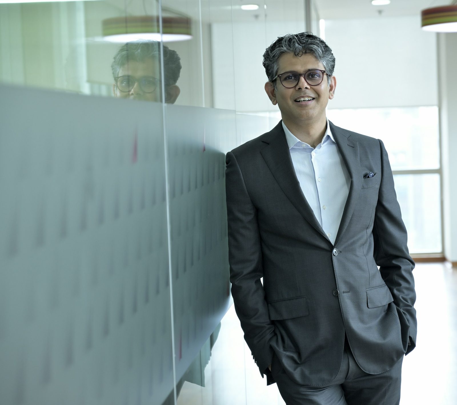 A business executive standing in an office hallway