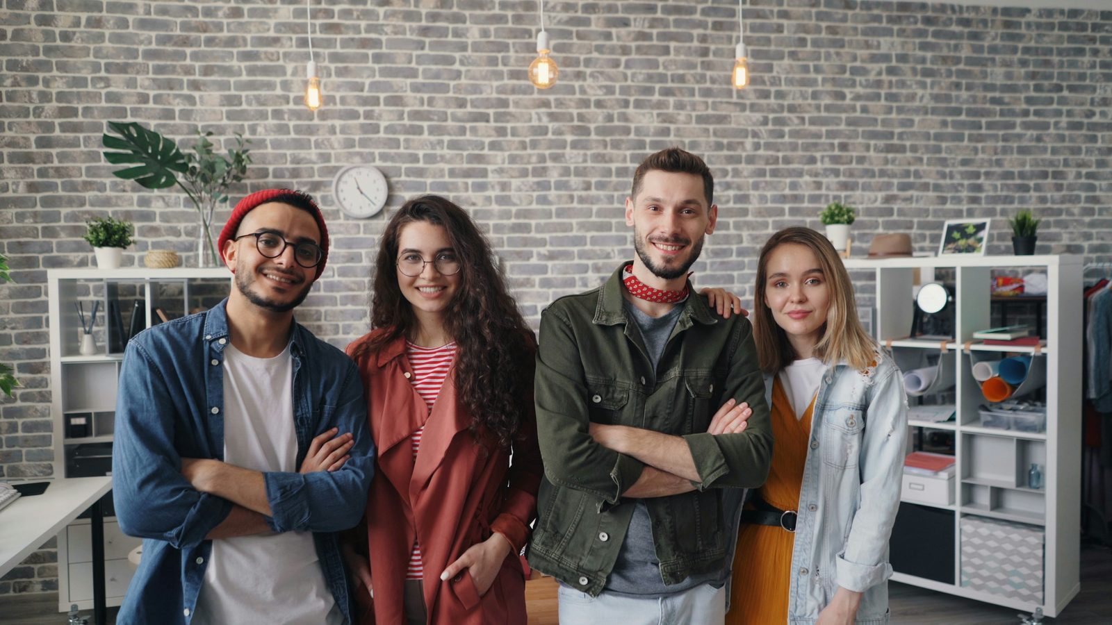 A small team standing together in their office