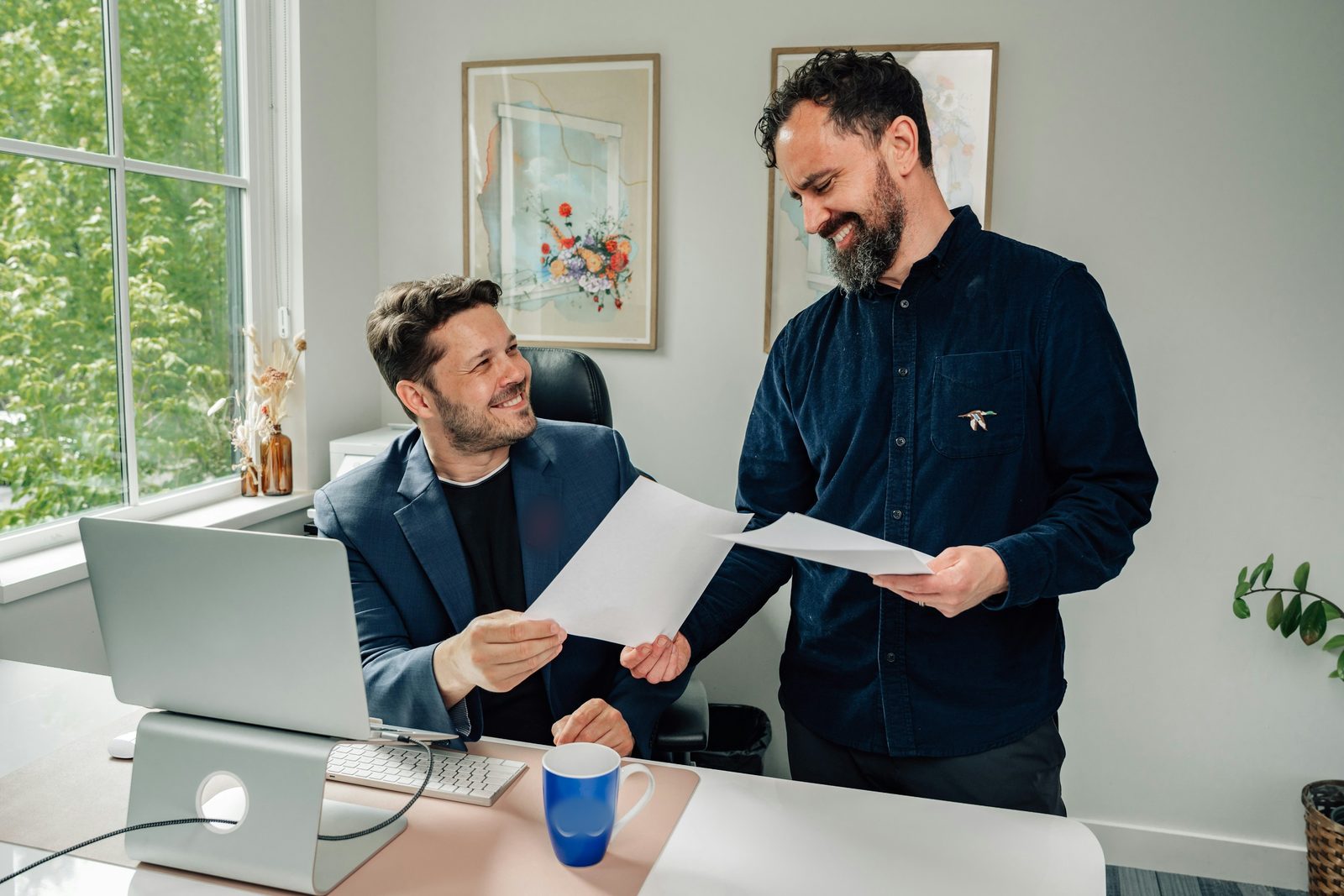 A business owner and an employee going over papers in an office