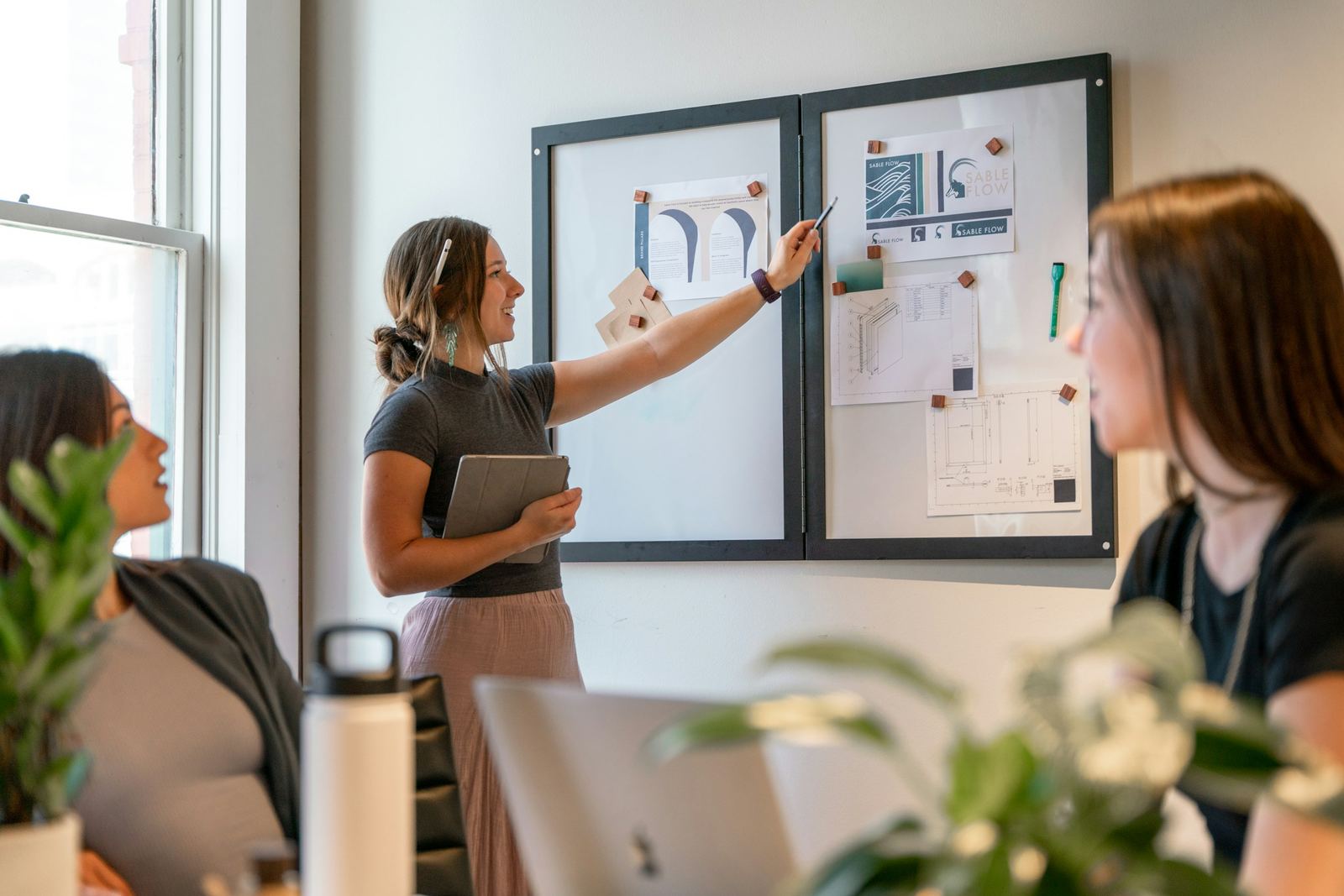 A small team meeting around a whiteboard