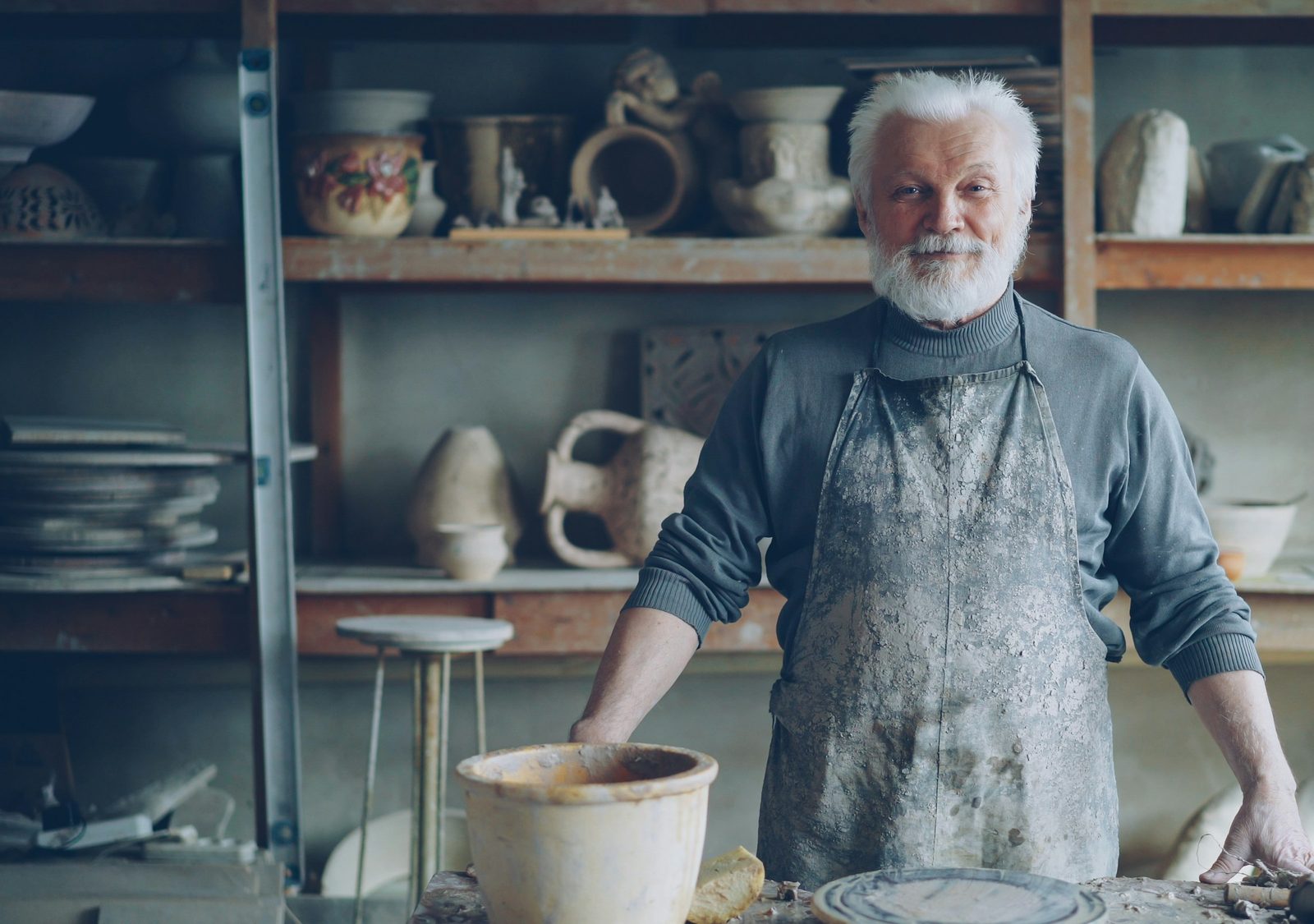 A potter standing in his workshop