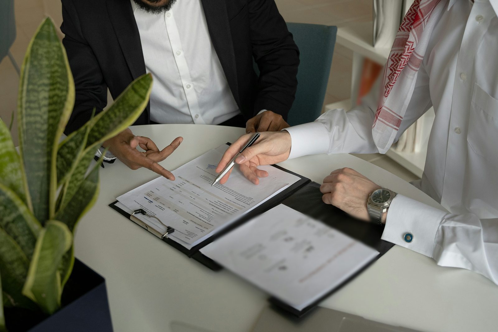 Two people going over loan paperwork at a table