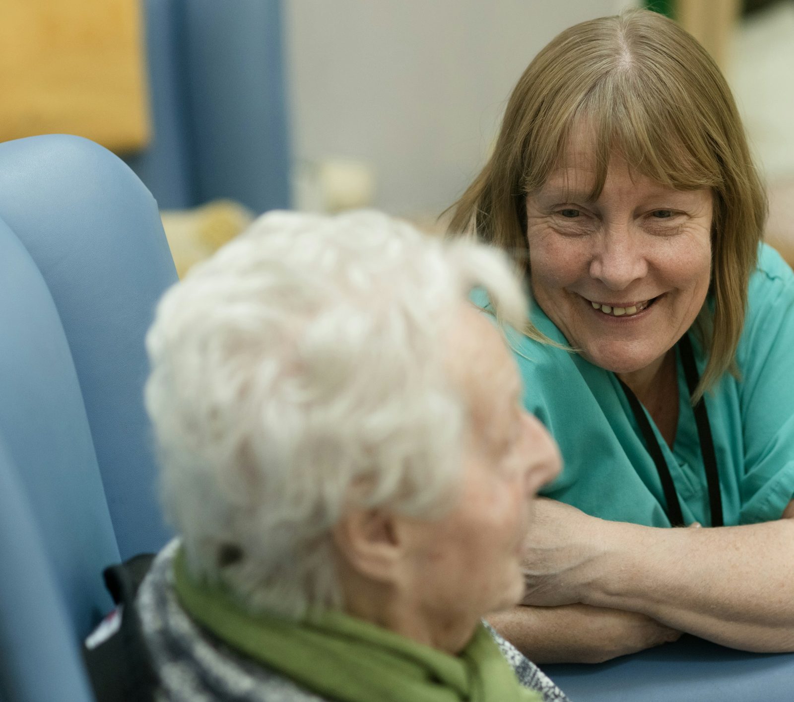 A caregiver smiling with an older woman