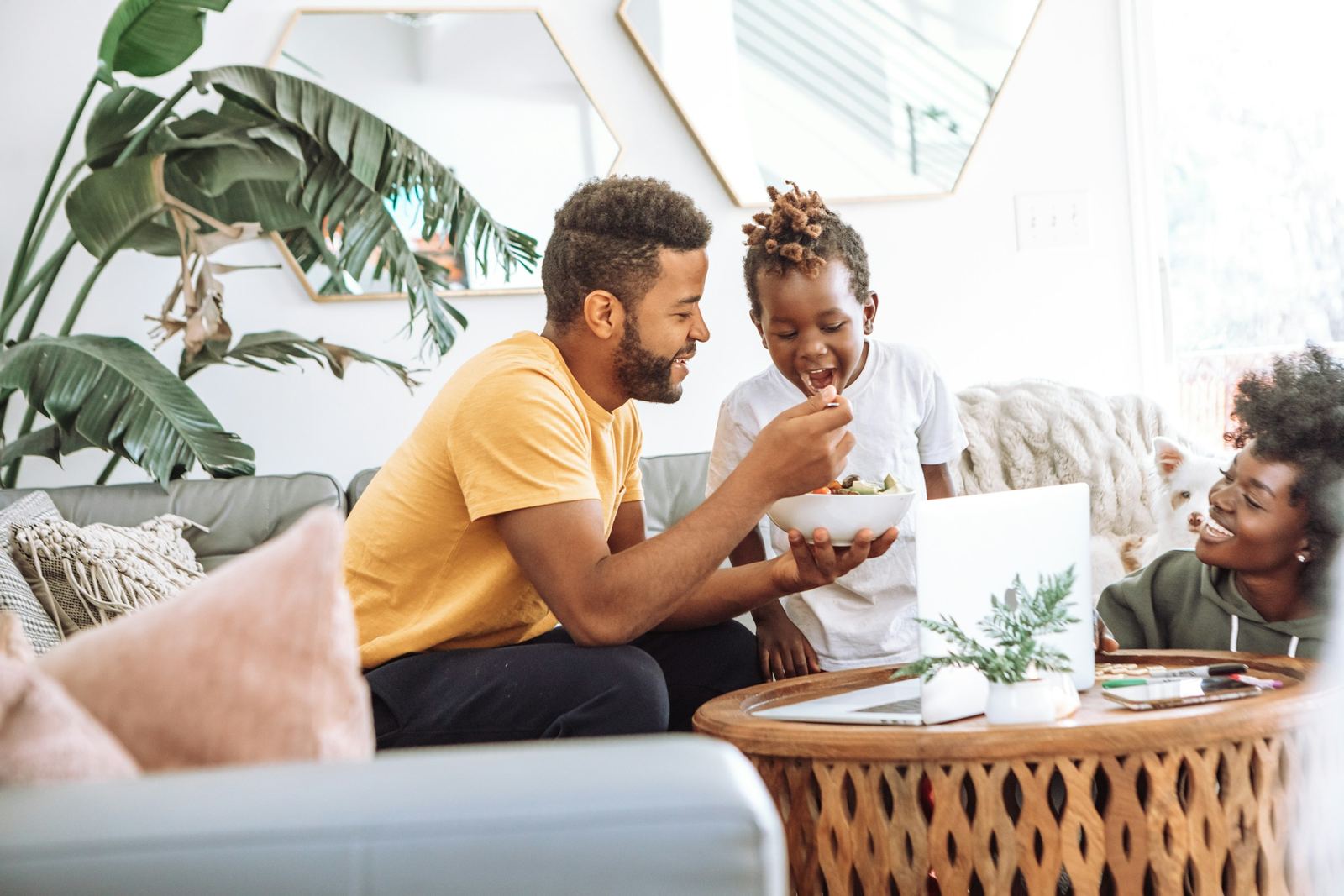 A family laughing together in their living room